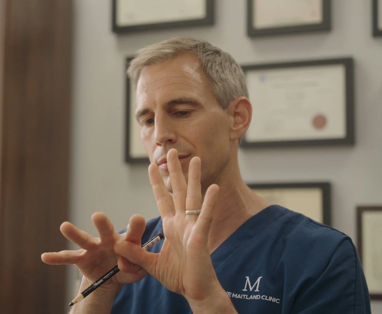 Dr Ball explaining treatment at a consultation